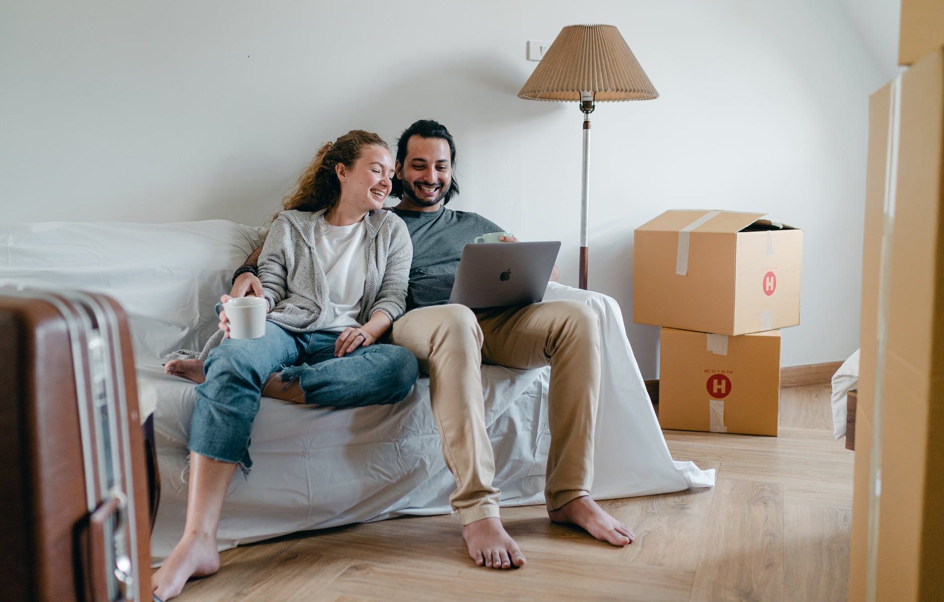 happy couple spending time together on sofa after moving